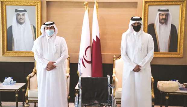 Officials marking the handover of the wheelchairs.
