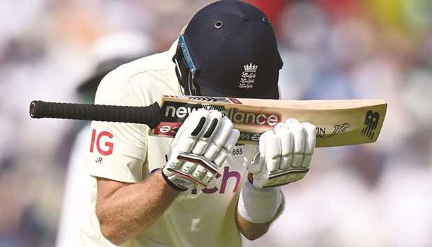 Englandu2019s captain Joe Root reacts as he walks back to the pavilion after losing his wicket during play on the fifth day of the fourth Test at the Oval cricket ground in London. (AFP)