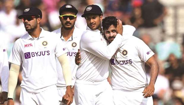 Indiau2019s Shardul Thakur (right) celebrates with teammates after taking the wicket of Englandu2019s Rory Burns on the fifth day of the fourth Test at the Oval cricket ground in London. (AFP)