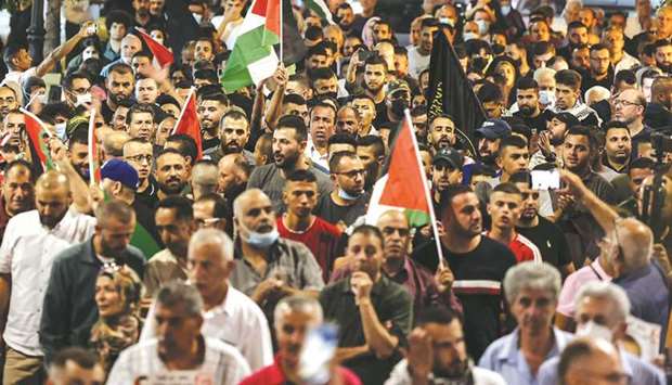 Demonstrators take part in a rally in support of Palestinian prisoners held in Israeli jails, in the occupied West Bank city of Ramallah, yesterday.