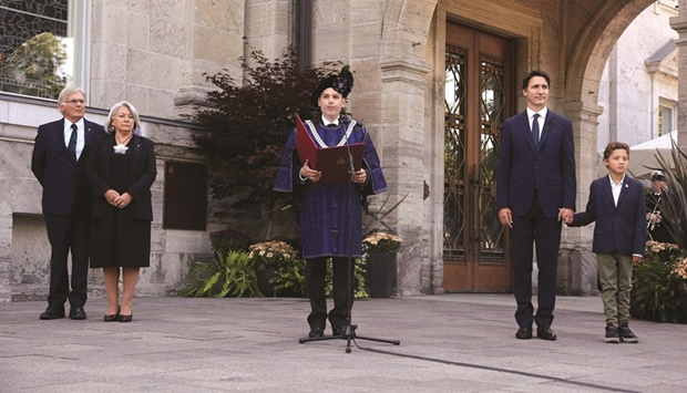 Chief Herald of Canada, Samy Khalid (left), reads a proclamation on the accession of Britainu2019s King Charles III during a ceremony at Rideau Hall yesterday in Ottawa, Canada, attended by Prime Minister Justin Trudeau and his son Hadrien (right), and Governor-General of Canada Mary Simon (second left) and her husband Whit Fraser.