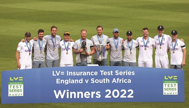 Englandu2019s captain Ben Stokes holds the trophy as he poses with his players after victory on the fifth and final day of the third Test against South Africa at The Oval, in London, yesterday. (AFP)