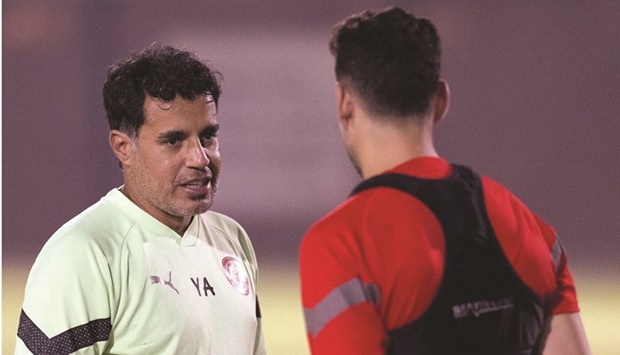 Al Arabi coach Younes Ali (left) talks to a player during their training session.