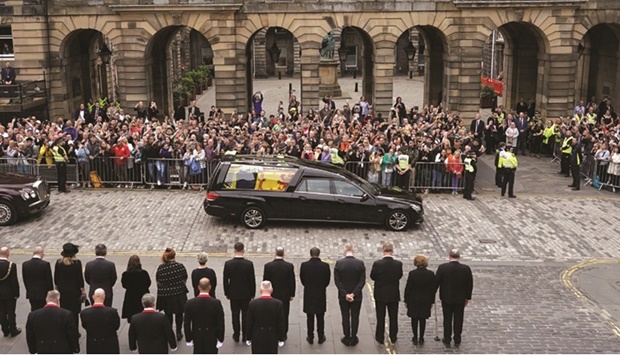 FAREWELL: Crowds watch the cortege carrying the coffin of Britainu2019s Queen Elizabeth in Edinburgh on Sunday. (Reuters)