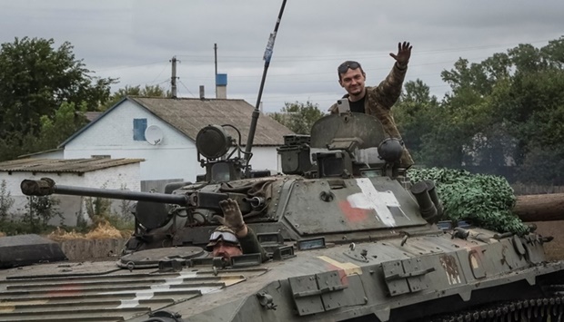 Ukrainian service members ride a BMP-2 infantry fighting vehicle, amid Russia's attack on Ukraine in Kharkiv region, Ukraine September 13. REUTERS