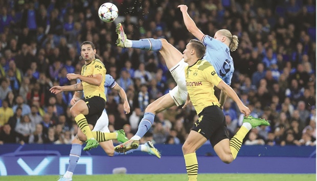 Manchester Cityu2019s Erling Haaland (centre) scores during the Champions League Group G match against Borussia Dortmund in Manchester on Wednesday. (AFP)