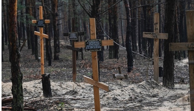 Crosses at a burial site in a forest on the outskirts of Izyum. - Ukraine said it had counted 450 graves at just one burial site near Izyum after recapturing the eastern city from the Russians. AFP