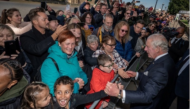 King Charles III meets members of the public in the queue along the South Bank, near to Lambeth Bridge, London, as they wait to view Queen Elizabeth II lying in state ahead of her funeral on Monday. Aaron Chown/Pool via REUTERS