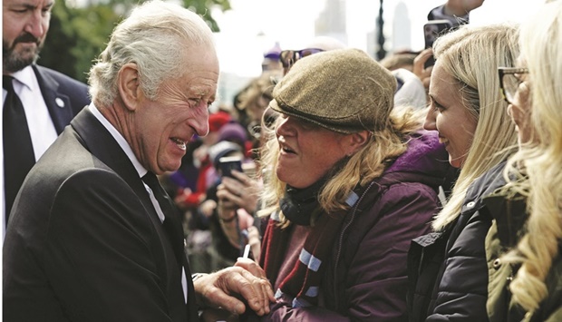 King Charles III meets members of the public in the queue along the South Bank, near to Lambeth Bridge, London, as they wait to view Queen Elizabeth II lying in state ahead of her funeral tomorrow.