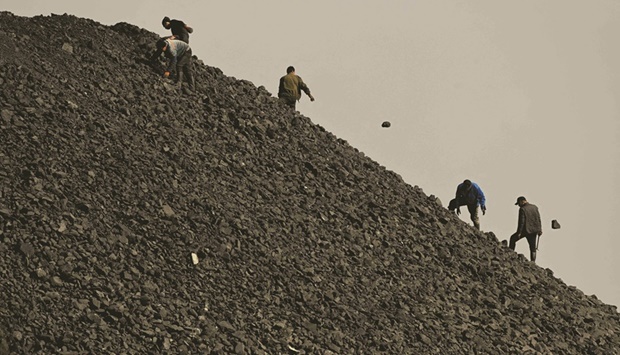 Workers sort coal near a coal mine in Datong, Chinau2019s northern Shanxi province (file). Overall carbon emissions in China have fallen for four consecutive quarters on the back of an economic slowdown, research reported by climate monitor Carbon Brief showed in early September.