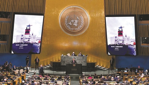 UN Secretary-General Antonio Guterres addresses the 77th session of the UNGA at UN headquarters in New York City yesterday as the ship Brave Commander, the first humanitarian cargo ship carrying 23,000 tonnes of wheat to leave from Ukraineu2019s port of Odesa port, is shown on screen. (AFP)