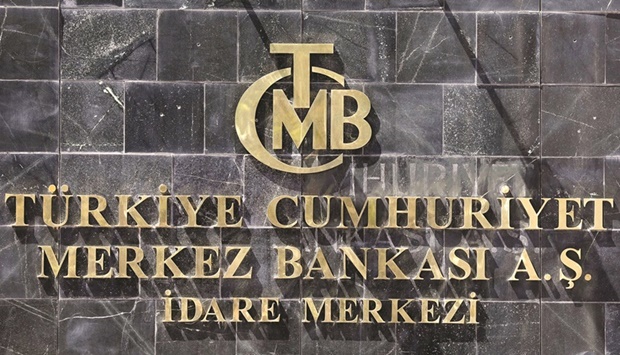 The logo of Turkiyeu2019s central bank (TCMB) at the entrance to its headquarters in Ankara (file). The central bank said it was cutting its one-week repo rate to 12% from 13% and blamed skyrocketing consumer prices on external factors such as the global jump in the cost of energy and food caused by Russiau2019s invasion of Ukraine.