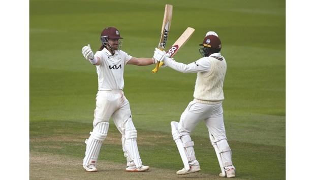 Rory Burns (left) and teammate Ryan Patel celebrate after the winning run against Yorkshire in the County Championship final at the Oval. (@surreycricket)