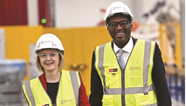 Britainu2019s Prime Minister Liz Truss and Britainu2019s Chancellor of the Exchequer Kwasi Kwarteng chat during a visit to Berkeley Modular, in Northfleet, in southeast England yesterday.