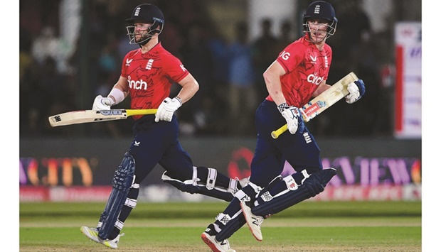 Englandu2019s Harry Brook (right) and Ben Duckett run between the wicket during the third Twenty20 international against Pakistan at the National Cricket Stadium in Karachi  yesterday. (AFP)