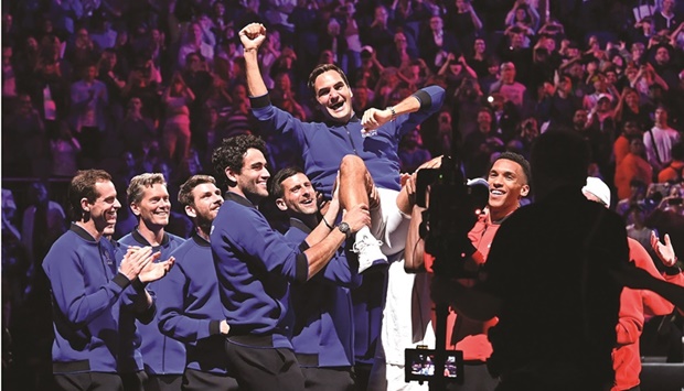 Roger Federer is lifted in the air by his Team Europe teammates and Team World players after playing his final match at the Laver Cup in London yesterday. (AFP)