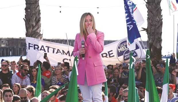 Leader of Italian far-right party u201cFratelli du2019Italiau201d, Giorgia Meloni, blows a kiss as she delivers a speech at a beachfront location in Naples, southern Italy, during a rally closing her partyu2019s campaign for todayu2019s general election. (AFP)