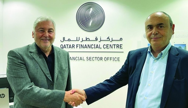 Fadi Saab, chairman of Trans Capital Finance (UK) and Bulent Karagoz, founding partner of Crescent Trade Finance (UK) shake hands after signing the agreement.