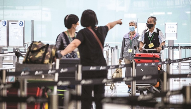 Travellers arrive at Hong Kong International Airport on Friday. Almost three years of pandemic restrictions have devastated Hong Kongu2019s economy and pushed residents and businesses to move overseas.