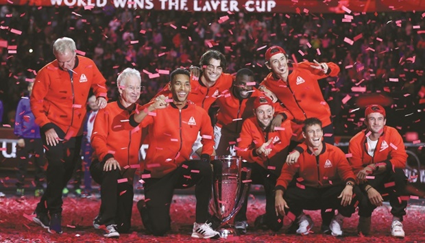 Team World (from left) vice captain Patrick McEnroe, captain John McEnroe, Canadau2019s Felix Auger-Aliassime, USAu2019s Taylor Fritz, USAu2019s Frances Tiafoe, USAu2019s Jack Sock, Australiau2019s Alex De Minaur, Argentinau2019s Diego Schwartzman and USAu2019s Tommy Paul pose with the trophy on the court after victory over Team Europe in the 2022 Laver Cup at the O2 Arena in London. (AFP)