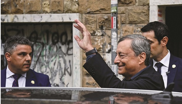 Italian Prime Minister Mario Draghi waves as he leaves after casting his vote at the Liceo Mameli  polling station in Rome yesterday. (AFP)