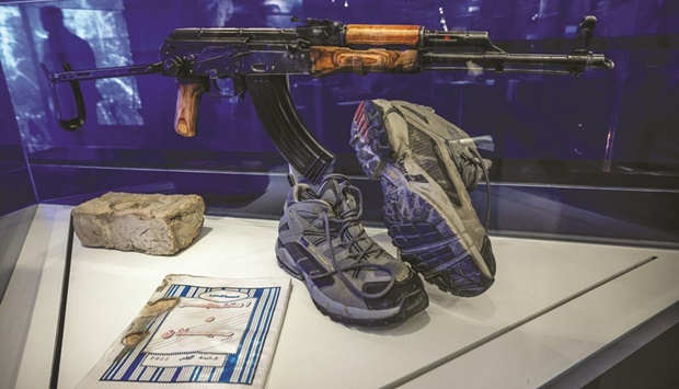 An AKM assault rifle that was found next to the body of Osama bin Laden the night he was killed at his compound in Pakistan by US Navy Seals, a brick from the compound, an Al Qaeda training manual and shoes worn by a Navy Seal, are on display at the revamped Central Intelligence Agency museum at CIA headquarters in McLean, Virginia. (Reuters)