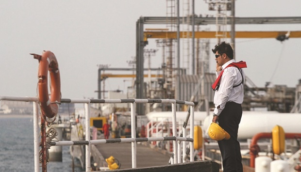 An Iranian technician stands at an oil facility in the Khark Island. The US has heavily sanctioned Iran and its oil sector. That and the extra Russian barrels have forced Tehran to offer buyers discounts.