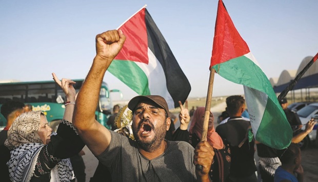 Palestinians shout slogans during a demonstration next to the border fence with Israel, east of Gaza City, yesterday.