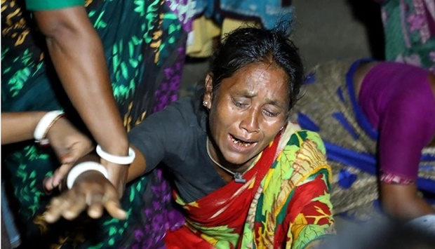 A relative of a victim who died after a boat capsized in river Karotoa, weeps near Boda town. AFP