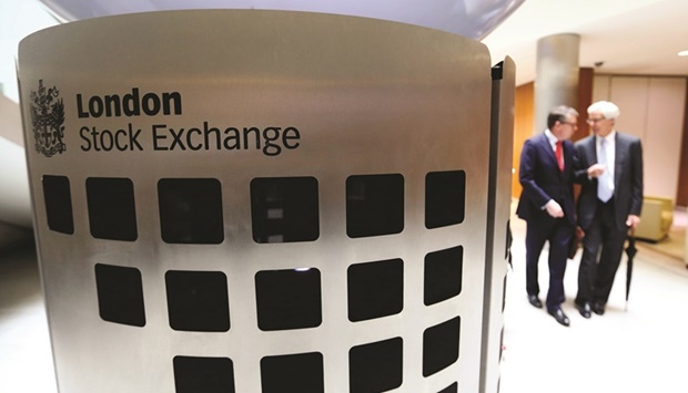 Visitors pass inside the main atrium of the London Stock Exchange. Investors are starting to dip back into UK assets after a historic bond selloff and a collapse in the pound to record lows.