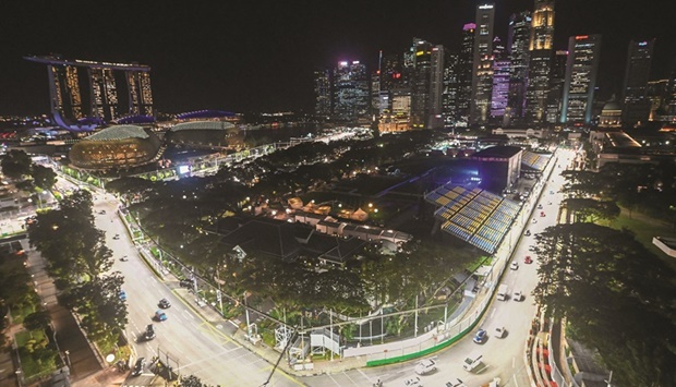 Cars drive on the illuminated race track for the upcoming Formula One Singapore Grand Prix, a night race, at the Marina Bay Street Circuit in Singapore yesterday. (AFP)