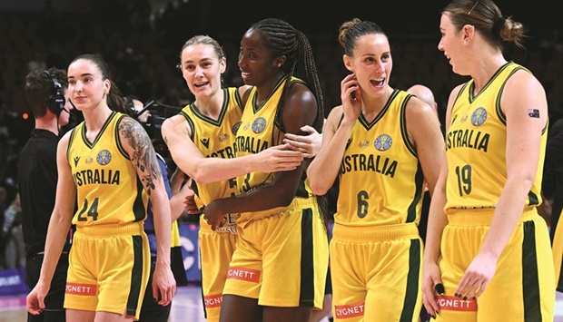 Australian players celebrate their victory during the Womenu2019s Basketball World Cup against Japan in Sydney yesterday. (AFP)