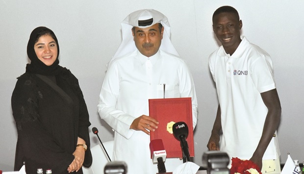 Heba Ali al-Tamimi, Ali Rashid al-Mohannadi and Khabane u2018Khabyu2019 Lame at the official signing ceremony yesterday. PICTURE: Thajudheen