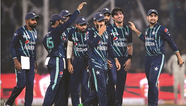 Pakistanu2019s players celebrate after the dismissal of Englandu2019s Ben Duckett (not pictured) during the fifth Twenty20 international against England at the Gaddafi Stadium in Lahore yesterday. (AFP)