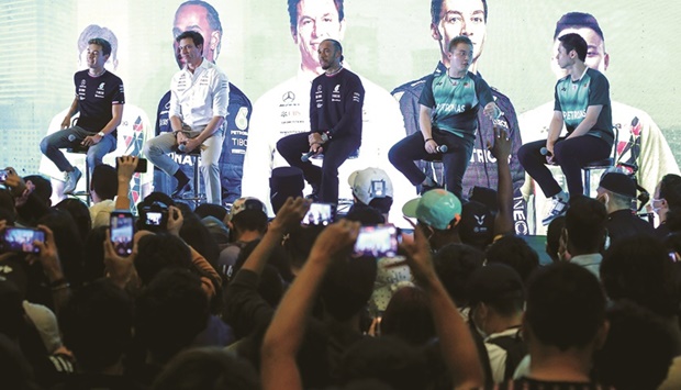 Drivers of Mercedes-AMG Petronas Formula One Team Lewis Hamilton (centre) and George Russell attend an event in Kuala Lumpur, Malaysia, ahead of the Singapore Grand Prix, yesterday. (Reuters)