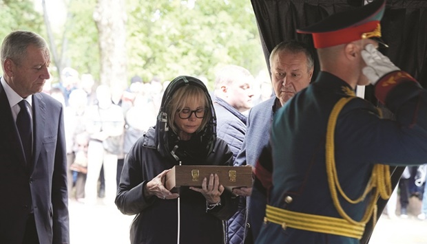 Irina Virganskaya, daughter of former Soviet Union president Mikhail Gorbachev, is presented with the flag during her fatheru2019s funeral at Novodevichy Cemetery in Moscow yesterday. (Reuters)