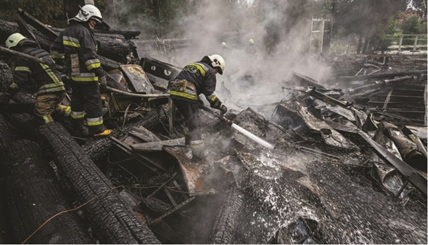 Firefighters douse the rubble of a restaurant complex destroyed by a missile strike in the second largest Ukrainian city of Kharkiv yesterday. (AFP)