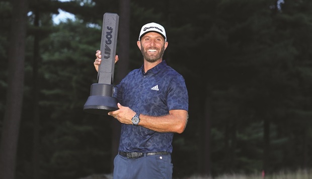Dustin Johnson of the United States holds the winneru2019s trophy after winning the LIV Golf Invitational u2013 Boston at The Oaks golf course in Bolton. (AFP)