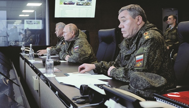 Russian President Vladimir Putin (centre), Defence Minister Sergei Shoigu (left) and Chief of the General Staff of Russian Armed Forces Valery Gerasimov oversee the Vostok-2022 (East-2022) military drills at Sergeyevsky training ground in the far eastern Primorsky Region yesterday. (Reuters)