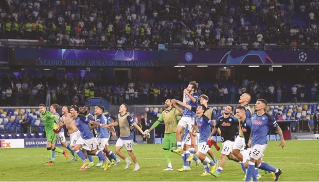 Napoliu2019s players celebrate after winning the Champions League Group A match against Liverpool at the Diego Armando Maradona Stadium in Naples on Wednesday. (AFP)