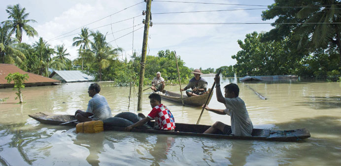 Residents use rafts as they make their way through floodwaters in Kalay, upper Myanmaru2019s Sagaing region, yesterday.