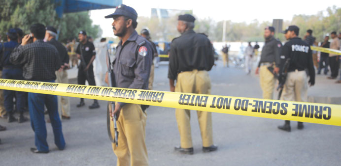 This file picture taken on April 19, 2014 shows Pakistani security personnel working at the scene after the attack on prominent Pakistani journalist H