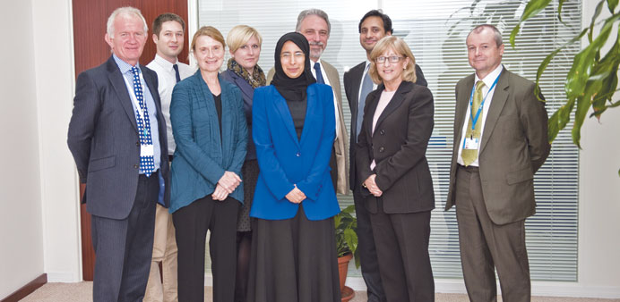 Al-Kuwari, flanked in the front row by other officials including professor Mike Richmond, Jesse McCall, Sheila Leatherman, Rachel Harvey, Frank Federi