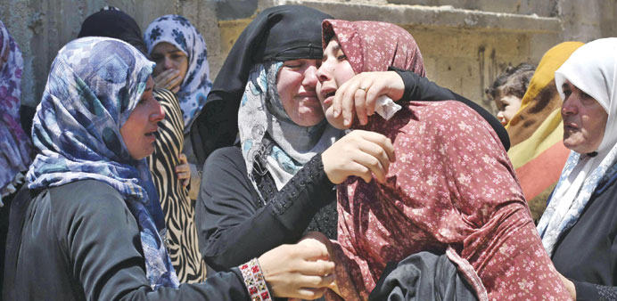 Relatives of Tawfiq al -Aga, who medics said was killed in Israeli shelling, mourn during his funeral in Khan Younis in the southern Gaza Strip yester