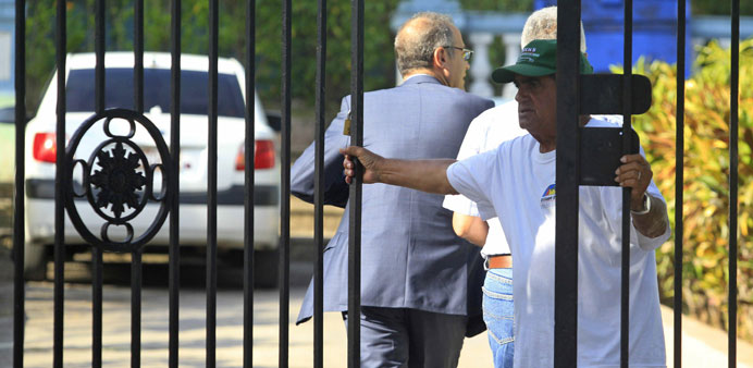 Men arrive at a court during the trial against Sarkis Yacoubian and Krikor Bayassalian in Havana yesterday.