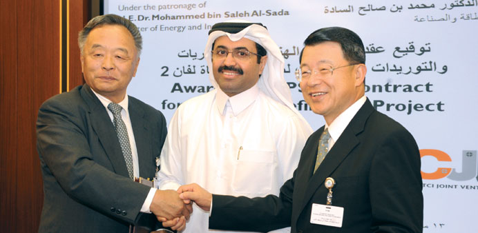 HE Dr al-Sada with Kubota (left) and John  Yu after concluding the agreement.