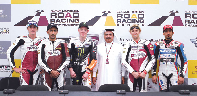 The winners of the Qatar International Road Racing Championship strike a pose during the press conference at the Losail Interantional Circuit yesterda