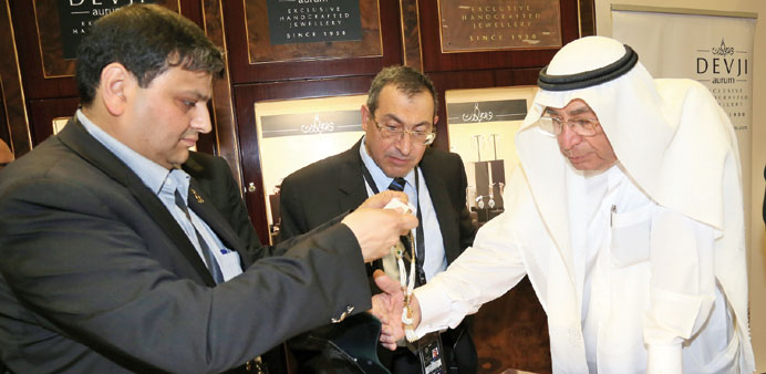 Kapil Dasani explaining the significance of an ornament to well-known Qatari jeweller Hussain Alfardan at Devjiu2019s counter in the Alfardan Jewellery pa