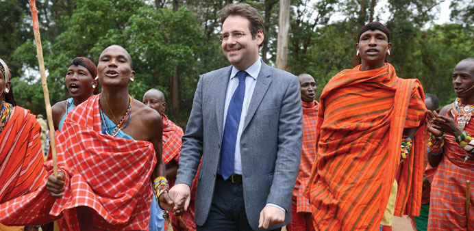 French Minister of Foreign Trade Matthias Fekl join Maasai traditional dancers during the inauguration yesterday of the digital radio network at the K