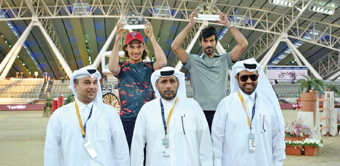 Champion Faleh Nasser Saleh Bughenaim of Al Shaqab and runner-up Bilal Bassam Shawqi al-Kharraz pose at the podium.